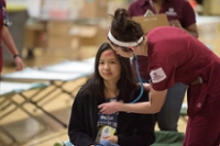 nursing student checking a patient with her stethoscope 